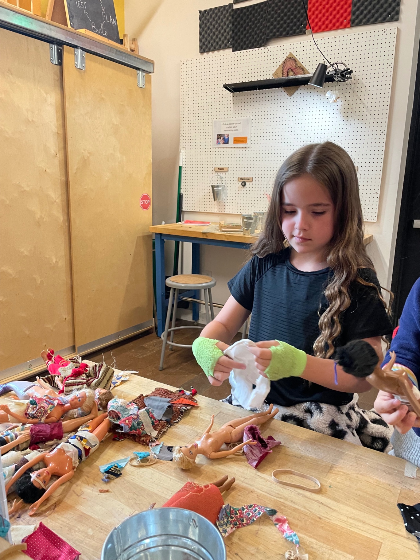 Sewing and reworking fabric outfits by hand in the studio